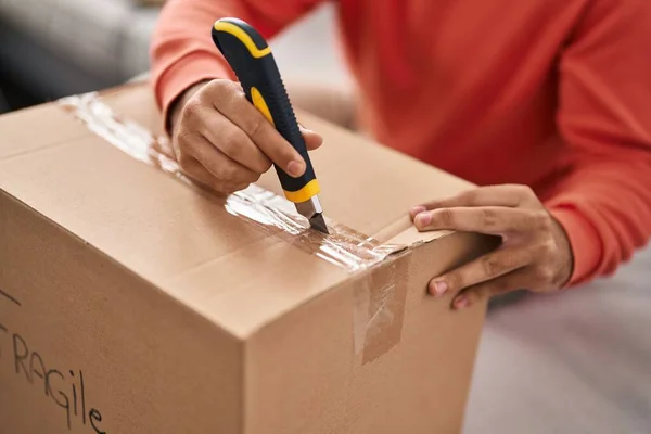 Young Hispanic Man Unpacking Cardboard Box New Home — Foto Stock