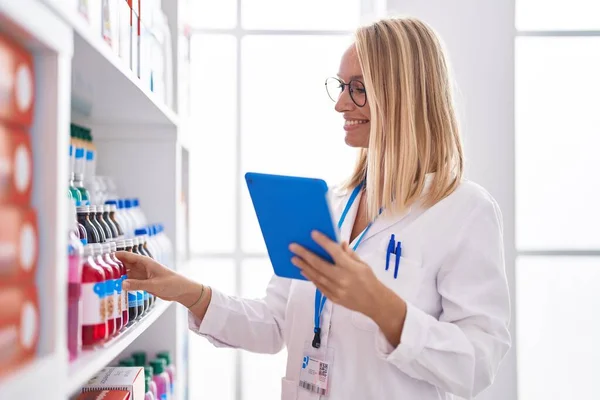 Young Blonde Woman Pharmacist Using Touchpad Working Pharmacy — Stock Photo, Image
