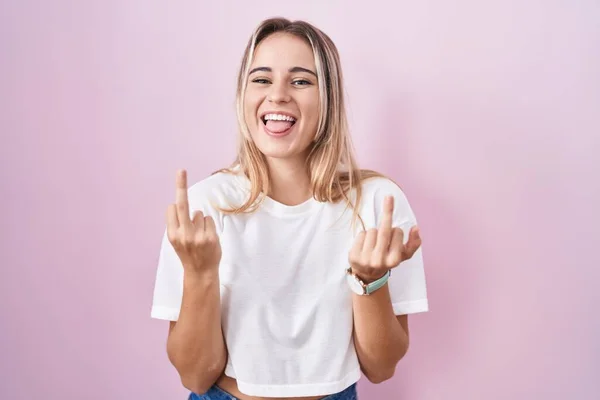 Young Blonde Woman Standing Pink Background Showing Middle Finger Doing — стоковое фото