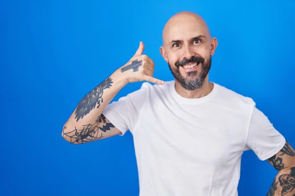 Hispanic Man Tattoos Standing Blue Background Smiling Doing Phone Gesture — Stock Photo, Image