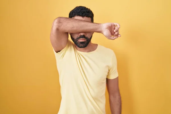 Hispanic Man Beard Standing Yellow Background Covering Eyes Arm Looking — Photo