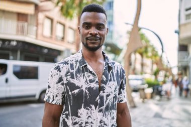 Young african american man smiling confident at street