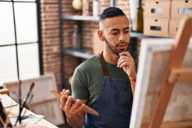 African american man artist drawing with doubt expression at art studio