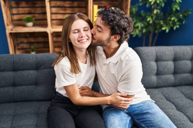 Man and woman kissing and hugging each other at home