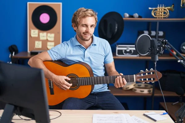 Caucasian Man Playing Classic Guitar Music Studio Winking Looking Camera — Fotografia de Stock