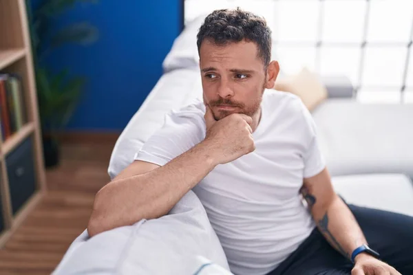 Young Hispanic Man Sitting Sofa Serious Expression Home — Stock Photo, Image