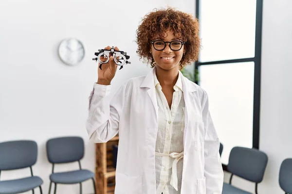 Young African American Woman Holding Optometry Glasses Medical Exam Looking — Φωτογραφία Αρχείου