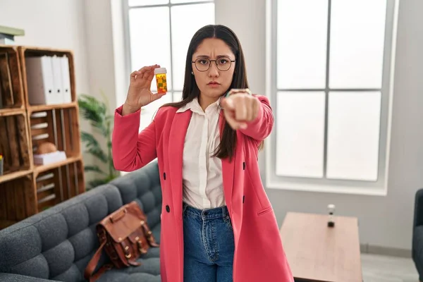 Young Latin Woman Working Therapist Holding Jar Pills Pointing Finger — Stockfoto