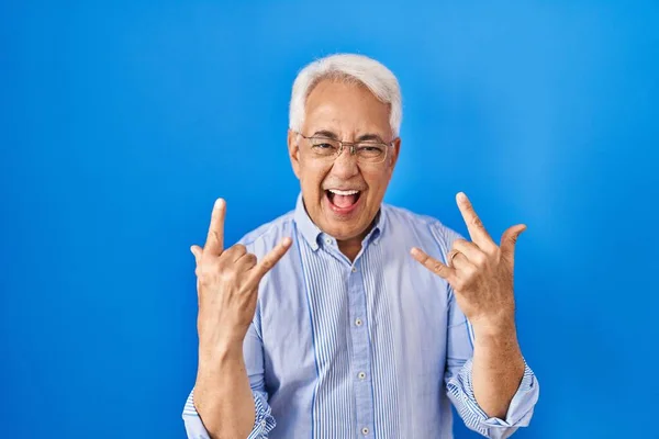 Hispanic Senior Man Wearing Glasses Shouting Crazy Expression Doing Rock — Stock Photo, Image