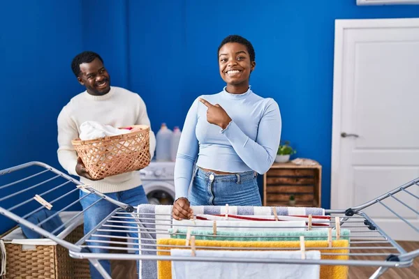 Young African American Couple Hanging Clothes Clothesline Smiling Happy Pointing — Stock Photo, Image