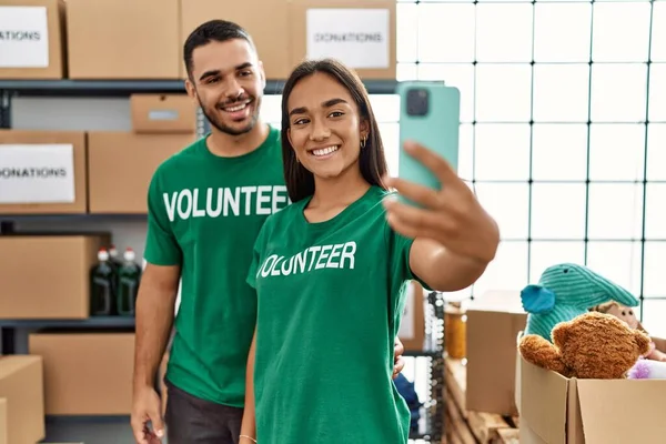 Young Latin Volunteer Couple Smiling Happy Making Selfie Smartphone Charity — Stock Photo, Image