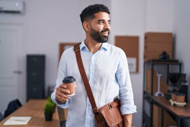 Young arab man business worker drinking coffee at office