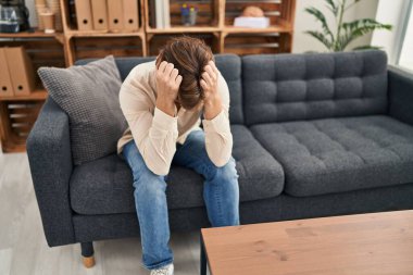 Young caucasian man patient stressed sitting on sofa at home