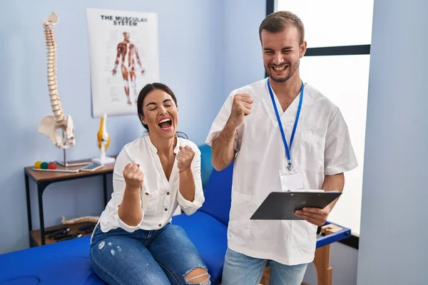 Young Hispanic Woman Physiotherapist Appointment Very Happy Excited Doing Winner — Stockfoto