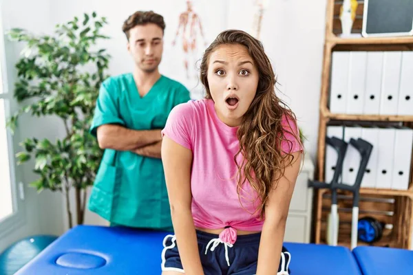 Young Hispanic Woman Physiotherapist Appointment Afraid Shocked Surprise Expression Fear — Stockfoto