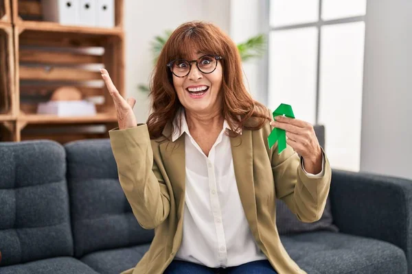 Middle Age Hispanic Woman Holding Support Green Ribbon Celebrating Victory — Stock Photo, Image