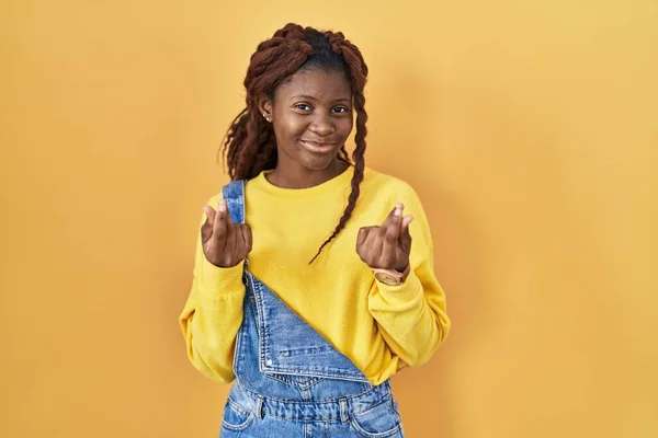 African Woman Standing Yellow Background Doing Money Gesture Hands Asking — ストック写真