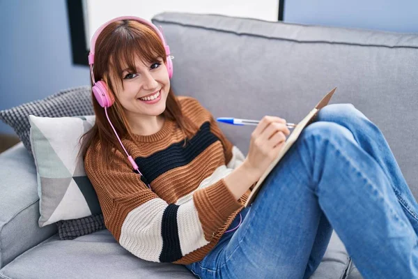 Mladá Žena Poslouchá Hudbu Psaní Notebooku Doma — Stock fotografie