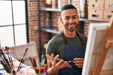 African american man artist smiling confident drawing at art studio