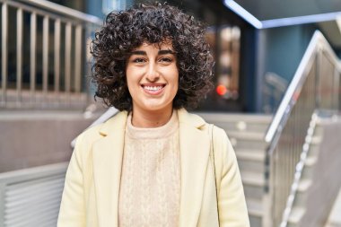 Young middle east woman excutive smiling confident standing at street