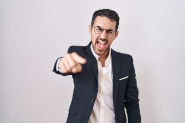 Handsome business hispanic man standing over white background pointing displeased and frustrated to the camera, angry and furious with you 