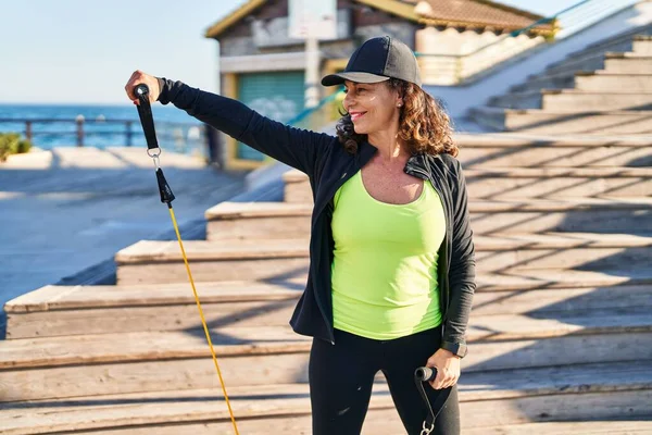 Middle Age Hispanic Woman Working Out Elastic Bands Outdoors — Stok fotoğraf
