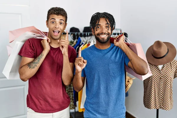 Young Hispanic Men Holding Shopping Bags Fashion Boutique Surprised Idea — ストック写真