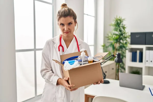 Young Doctor Woman Holding Box Medical Items Skeptic Nervous Frowning — Stock Photo, Image