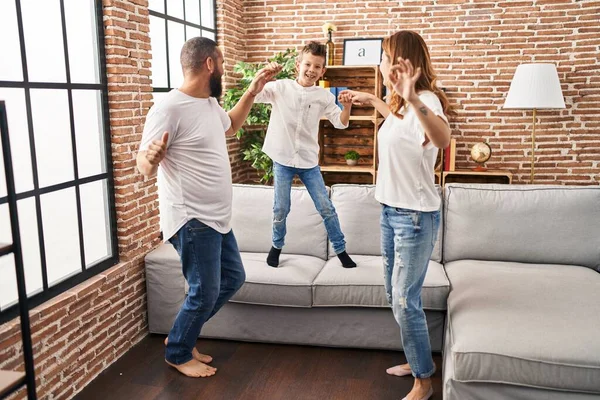 Family smiling confident dancing at home