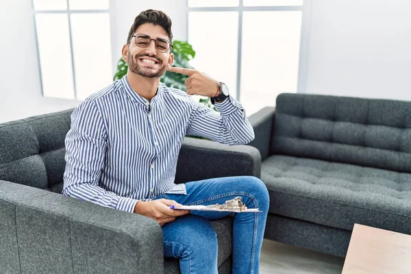 Young Psychologist Man Consultation Office Smiling Cheerful Showing Pointing Fingers — Stockfoto