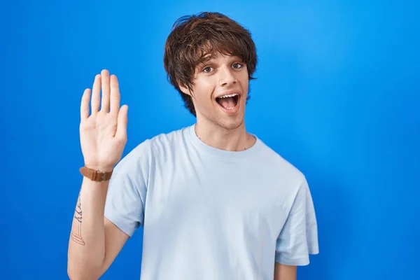 Hispanic Young Man Standing Blue Background Waiving Saying Hello Happy — Stock Photo, Image