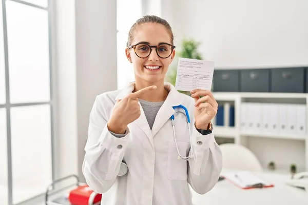 Young Doctor Woman Holding Covid Certificate Smiling Happy Pointing Hand — Foto de Stock