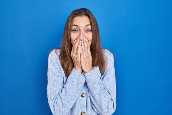 Young Woman Standing Blue Background Laughing Embarrassed Giggle Covering Mouth — 스톡 사진