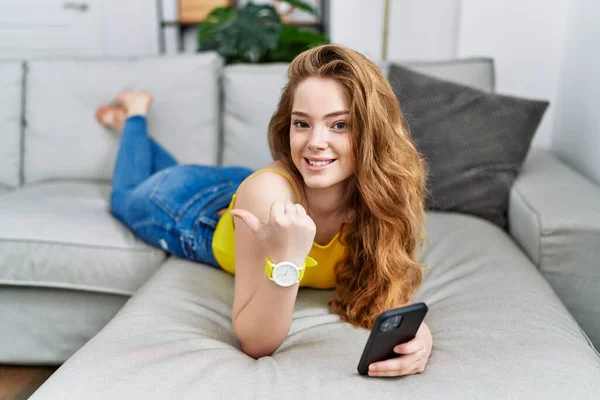 Young Caucasian Woman Lying Sofa Using Smartphone Pointing Back Hand — Foto de Stock