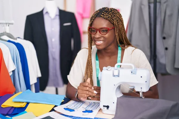 African american woman tailor smiling confident speaking at tailor shop