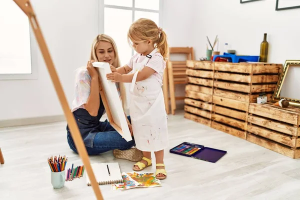 Mother Daughter Smiling Confident Drawing Canvas Sitting Floor Art Studio — 图库照片