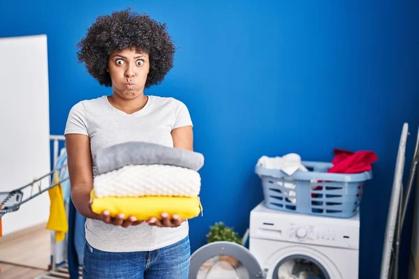 Black Woman Curly Hair Holding Clean Laundry Puffing Cheeks Funny — ストック写真