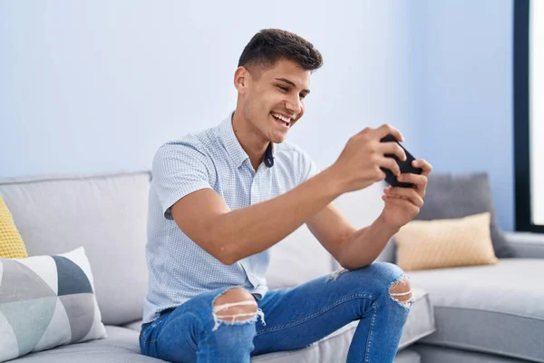 Young Hispanic Man Playing Video Game Sitting Sofa Home — Stock fotografie