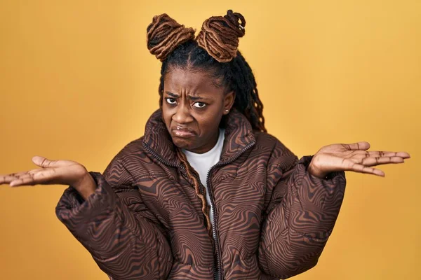 African Woman Braided Hair Standing Yellow Background Clueless Confused Expression — ストック写真