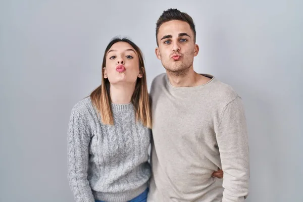 Young Hispanic Couple Standing White Background Looking Camera Blowing Kiss — Stockfoto