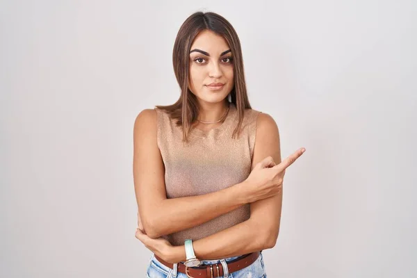 Young Hispanic Woman Standing White Background Pointing Hand Finger Side — Zdjęcie stockowe