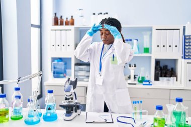 African american woman scientist holding test tube at laboratory