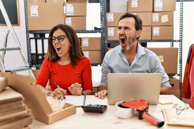 Küçük işletme şirketinde çalışan orta yaşlı bir çift kızgın ve kızgın çığlıklar atıyorlar. Öfkeyle bağırıyorlar. öfke ve agresif konsept. 