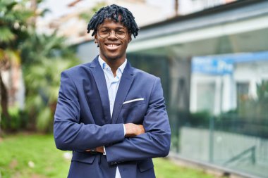 African american man executive smiling confident standing with arms crossed gesture at park