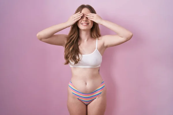 Caucasian Woman Wearing Lingerie Pink Background Covering Eyes Hands Smiling — Stock Photo, Image