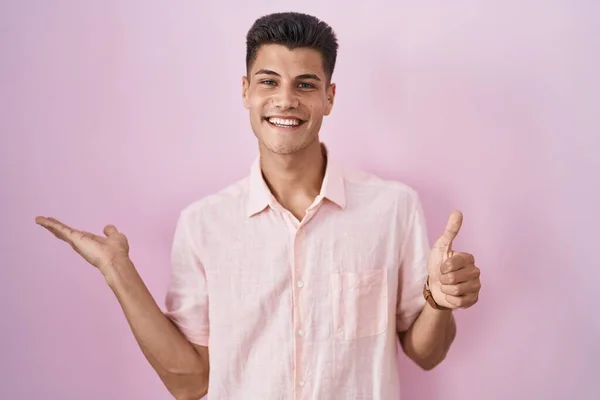 Jovem Hispânico Sobre Fundo Rosa Mostrando Palma Mão Fazendo Gesto — Fotografia de Stock