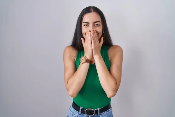 Young Woman Standing Isolated Background Laughing Embarrassed Giggle Covering Mouth — Stock Fotó
