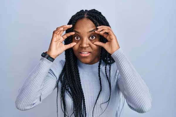 African American Woman Standing Blue Background Trying Open Eyes Fingers — стоковое фото