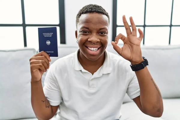 Young African Man Holding Deutschland Passport Doing Sign Fingers Smiling — Foto Stock