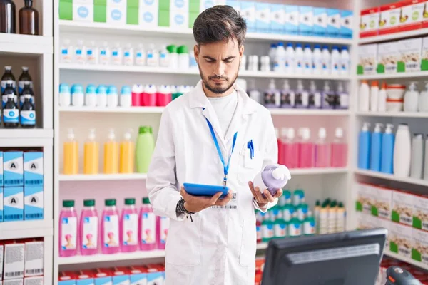 Young Hispanic Man Pharmacist Using Touchpad Holding Gel Hands Bottle — Stock Photo, Image